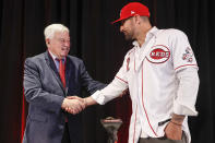 Cincinnati Reds Nick Castellanos, right, shakes hands with Reds chief executive owner Bob Castellini during a news conference announcing his signing with the baseball club, Tuesday, Jan. 28, 2020, in Cincinnati. Castellanos signed a $64 million, four-year deal with the Reds. (AP Photo/John Minchillo)