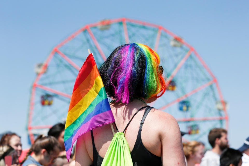 A participant wears a LGBT flag as people take part in the Annual Mermaid Parade in Brooklyn, New York, June 18, 2016. REUTERS/Eduardo Munoz