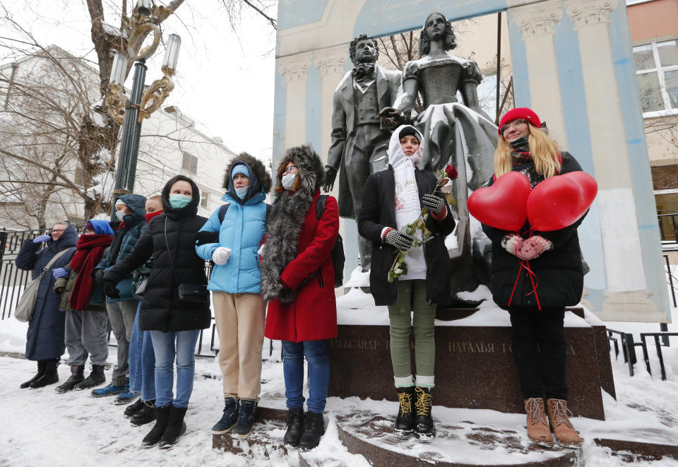 Women, some of them wearing face masks to protect against coronavirus, attend a rally in support of jailed opposition leader Alexei Navalny and his wife Yulia Navalnaya, in Moscow, Russia, Sunday, Feb. 14, 2021. (AP Photo/Alexander Zemlianichenko)