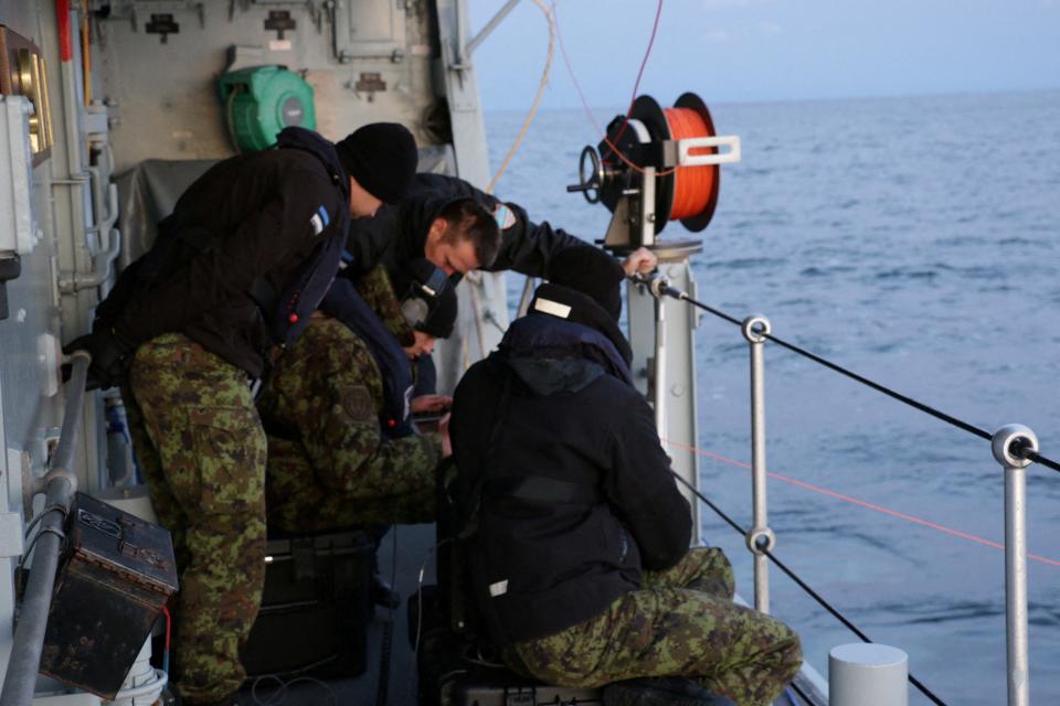 Estonian navy officers conduct an undersea communications cable survey (via REUTERS)