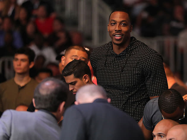 Dwight Howard takes in the fights. (Getty Images)