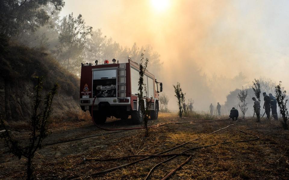 Firemen battle to extinguish fire during the second day of the wildfire on the island of Rhodes - LEFTERIS DAMIANIDIS/EPA-EFE/Shutterstock