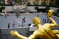 People roller skate at Rockefeller Center Tuesday, June 21, 2022, in New York. The summer of 2022 can feel as if the coronavirus pandemic is really over. Mask rules and testing requirements are lifting in many countries, including the United States. (AP Photo/Frank Franklin II)