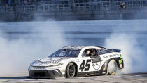 Tyler Reddick celebrates his win after a NASCAR Cup Series auto race at Talladega Superspeedway, Sunday, April 21, 2024, in Talladega. Ala. (AP Photo/Mike Stewart)