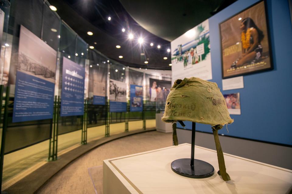 Mike Thornton, curator and interim executive director, talks about a helmet cover worn by Lance Cpl. William "Billy" Dutches, the first soldier from Hawthorne to be killed in the Vietnam War, which is displayed in the special exhibition, There and Back: The Journey to Vietnam and Home, at the Vietnam Era Museum and Education Center in Holmdel, NJ Thursday, November 3, 2022. 