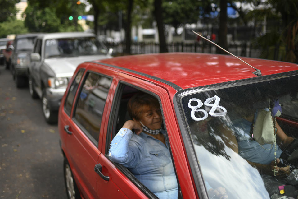 A car is marked with a number as its occupants wait for hours to fill up with gasoline at a state oil company PDVSA gas station in Caracas, Venezuela, Monday, May 25, 2020. The first of five tankers loaded with gasoline sent from Iran this week is expected to temporarily ease Venezuela's fuel crunch while defying Trump administration sanctions targeting the two U.S. foes. (AP Photo/Matias Delacroix)