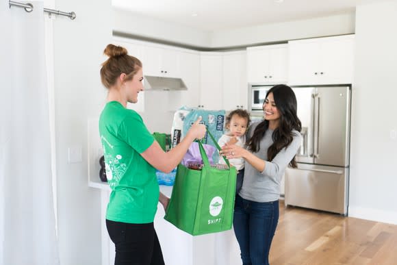 A Shipt shopper delivers same-day groceries at a customer's home