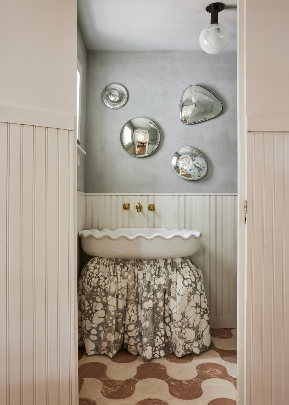 A basin with a skirt covering a trash can