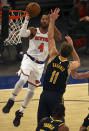 New York Knicks' Derrick Rose (4) heads for the net as Indiana Pacers' Domantas Sabonis (11) defends in the third quarter of an NBA basketball game Saturday, Feb. 27, 2021, in New York. (Elsa/Pool Photo via AP)
