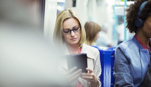 Businesswoman using digital tablet on train