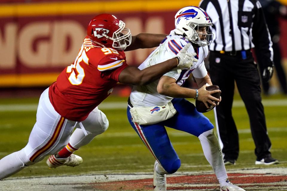 Kansas City Chiefs defensive tackle Chris Jones, left, tackles Buffalo Bills quarterback Josh Allen during the  AFC championship game, Sunday, Jan. 24, 2021.