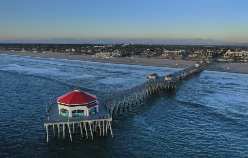 HUNTINGTON BEACH, CA - January 26: A drone view of the sun setting over Ruby's Diner, which has been located at the end of the Huntington Beach Pier for nearly 30 years, and will close Friday night following bankruptcy proceedings. The diner opened in 1993, will be replaced by a seafood restaurant. Photo taken Tuesday, Jan. 26, 2021 in Huntington Beach, CA. (Allen J. Schaben / Los Angeles Times)