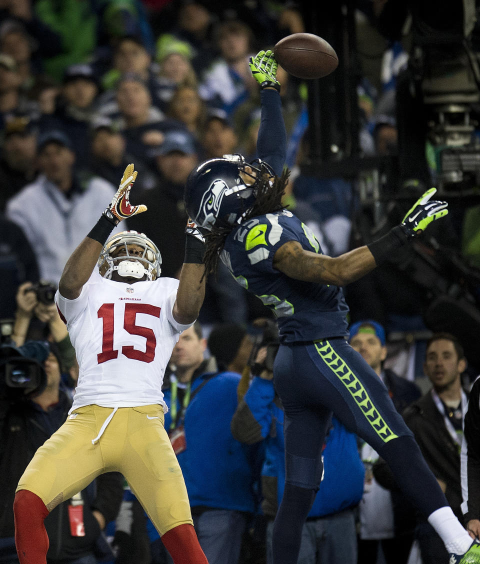 File-This Jan. 19, 2014 file photo shows Seattle Seahawks cornerback Richard Sherman (25) hitting the ball away from San Francisco 49ers wide receiver Michael Crabtree (15) and is intercepted by Seattle Seahawks outside linebacker Malcolm Smith (53) during the NFL football NFC Championship game, in Seattle. As part of its celebration of its 100th season, the NFL is designating a Game of the Week, each chosen to highlight a classic matchup. For this week, it’s the 49ers-Seahawks game. To mark each Game of the Week, the AP will be reprinting its story of a classic matchup in the rivalry. This week it's the Seattle Seahawks' 23-17 win over the San Francisco 49ers in the NFC championship game on Jan. 19, 2014. (Paul Kitagaki Jr./The Sacramento Bee via AP, File)