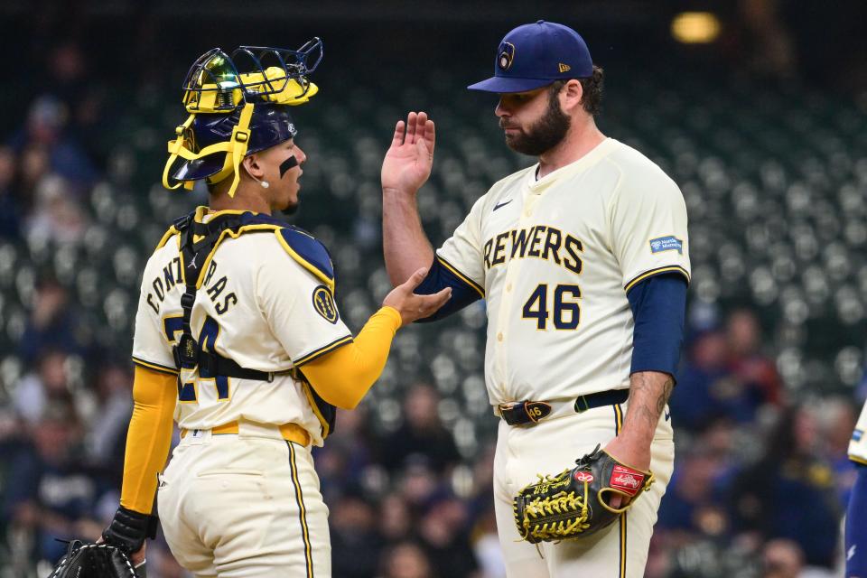 Apr 17, 2024; Milwaukee, Wisconsin, USA; Milwaukee Brewers pitcher Bryse Wilson (46) exchange handshakes with catcher William Contreras (24) during a pitching change in the fourth inning against the San Diego Padres at American Family Field. Mandatory Credit: Benny Sieu-USA TODAY Sports