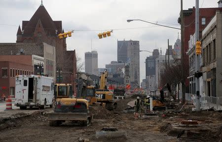 Crew work on constructing the new M-1 Rail streetcar project along Woodward Avenue in Detroit, Michigan, December 2, 2015. REUTERS/Rebecca Cook