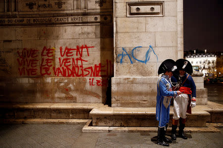 Graffiti is seen on a vandalized wall at the Arc de Triomphe the day after clashes with protesters wearing yellow vests, a symbol of a French drivers' protest against higher diesel taxes, in Paris, France, December 2, 2018. REUTERS/Stephane Mahe