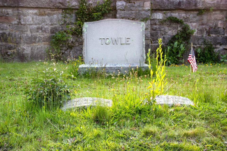 A gravesite is overgrown at Oak Grove Cemetery. Potential changes as part of the cemetery's master plan could mean altering some of the turf to make the cemetery easier to maintain.