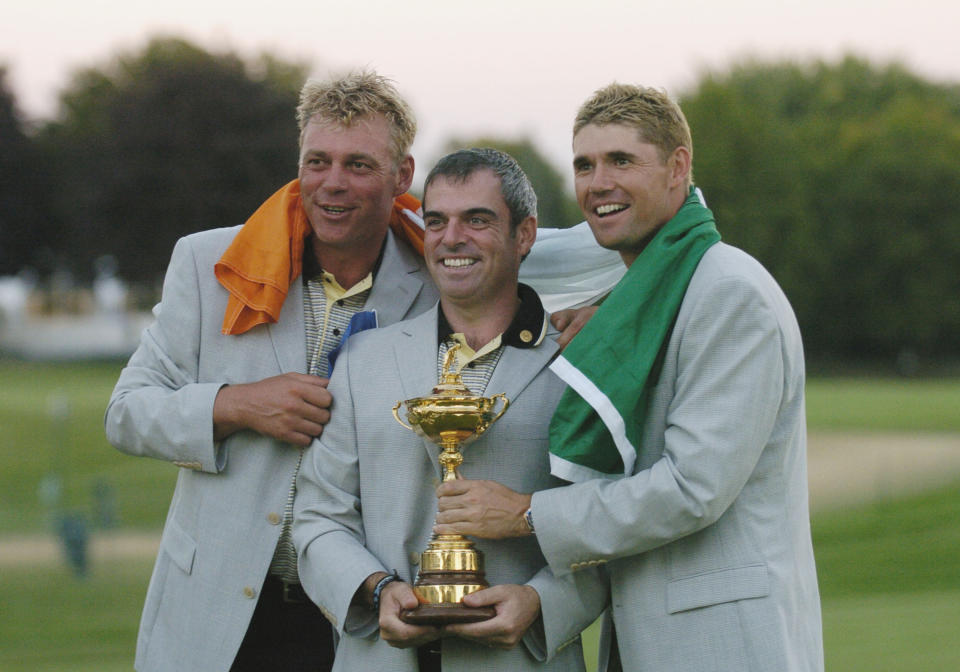 Darren Clarke, Paul McGinley and Padraig Harrington hold the prize as the European team celebrates winning the 2004 Ryder Cup in Detroit, Michigan, September 19, 2004. (Photo by A. Messerschmidt/Getty Images)