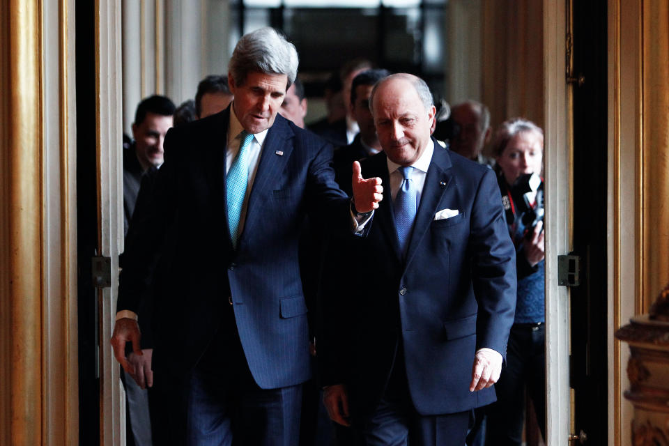 U.S. Secretary of State John Kerry, left, and his French counterpart Laurent Fabius arrive for a meeting at the Quai d'Orsay, in Paris, Sunday, March 30, 2014. After a week of travel in the Mideast, Kerry changed course and arrived in Paris Saturday for talks with his Russian counterpart on the Ukraine crisis. (AP Photo/Thibault Camus)