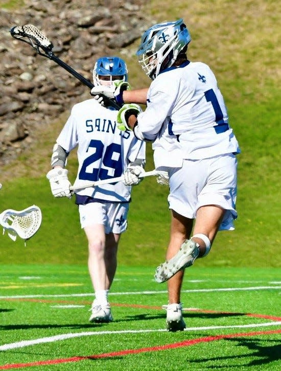 St. Thomas Aquinas junior Jackson Estes, right, scored three goals, including the 100th of his career, in Wednesday's Division II win over Merrimack.