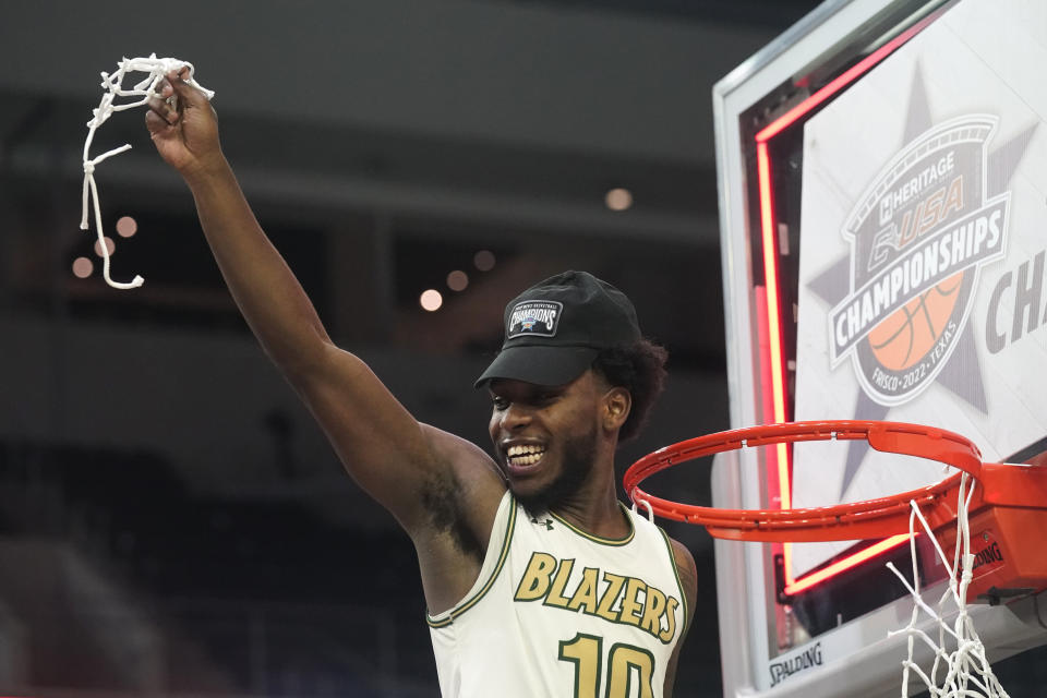 FILE - UAB guard Jordan Walker (10) holds up a piece of net after the team's win over Louisiana Tech in an NCAA college basketball game for the championship of the Conference USA men's tournament in Frisco, Texas, on March 12, 2022. After starting his career at Seton Hall and playing two seasons at Tulane, Walker has found a home at UAB. Walker ranked eighth in Division I in 3-pointers per game (3.41) and 16th in points per game (20.3) last season while leading Conference USA in both categories. He was named Conference USA player of the year. (AP Photo/LM Otero, File)