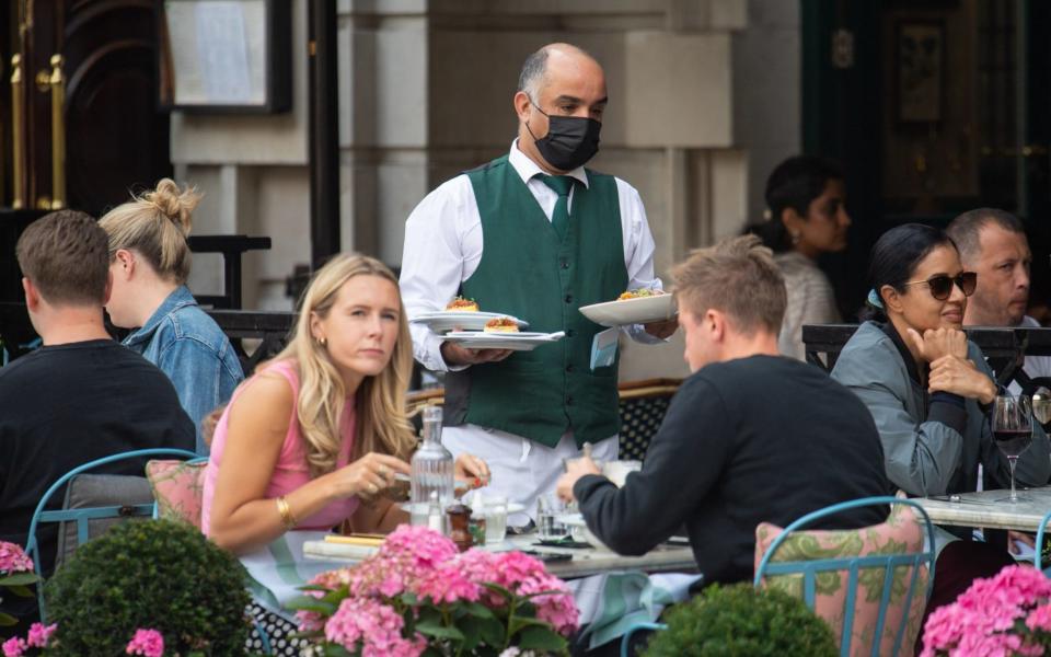 Waiter serving customers in London