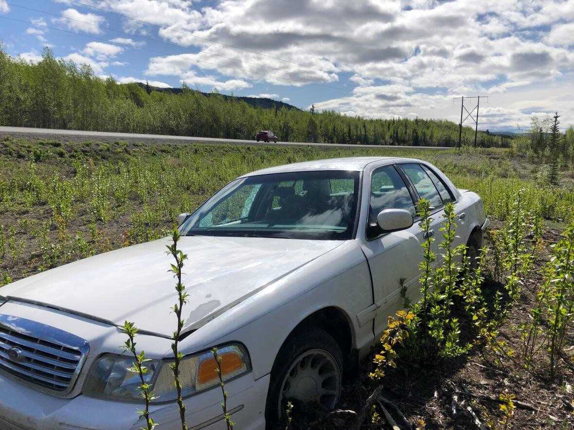 The Yukon government acknowledges there's an 'excessive number' of abandoned vehicles scattered alongside Yukon highways, but it's not clear who will clean them up or when. (Cheryl Kawaja/CBC - image credit)