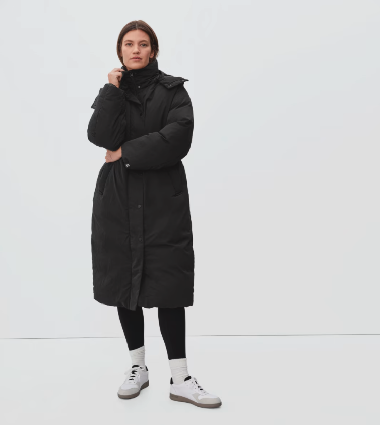 Model wears Everlane The Duvet Puffer in black