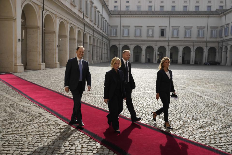 Brothers of Italy's leader Giorgia Meloni, and party member Francesco Lollobrigida, left, arrive at the Quirinale Presidential Palace for a meeting with Italian President Sergio Mattarella as part of a round of consultations with party leaders to try and form a new government, in Rome, Friday, Oct. 21, 2022. (AP Photo/Alessandra Tarantino)