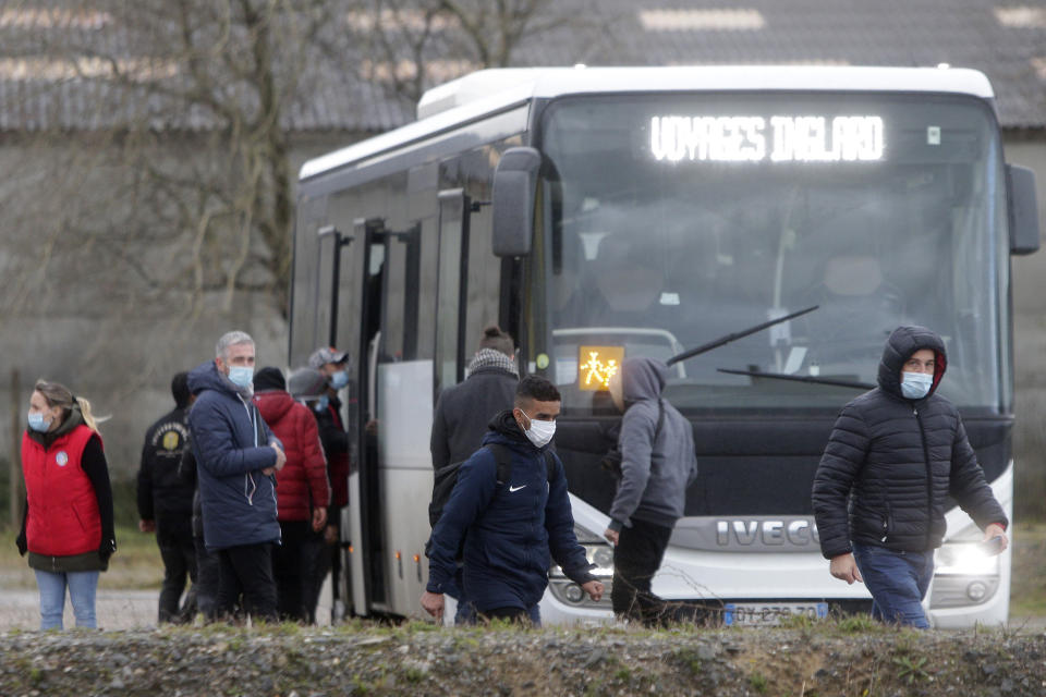 Migrants board a bus at a volunteers center, Thursday, Nov. 25, 2021 in Calais, northern France. Children and pregnant women were among at least 27 migrants who died when their small boat sank in an attempted crossing of the English Channel, a French government official said Thursday. French Interior Minister Gerald Darmanin also announced the arrest of a fifth suspected smuggler thought to have been involved in what was the deadliest migration tragedy to date on the dangerous sea lane.(AP Photo/Michel Spingler)