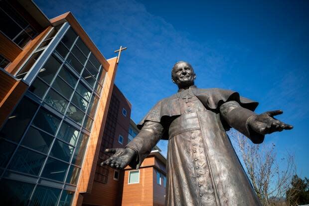 A statue of Pope John Paul II welcomes visitors to the Catholic Archdiocese of Vancouver. The archdiocese is facing a lawsuit from a B.C. man who claims he was sexually assaulted in the late 70s at a summer camp run by the church. (Ben Nelms/CBC - image credit)
