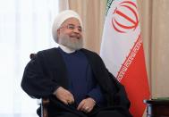 Iranian President Hassan Rouhani smiles as he speaks to Russian President Vladimir Putin during their talks on a sideline of the Shanghai Cooperation Organization summit in Bishkek, Kyrgyzstan, Friday, June 14, 2019. Iran's President Hassan Rouhani has called for closer cooperation between Tehran and Moscow amid rising regional tensions. (Alexei Druzhinin, Sputnik, Kremlin Pool Photo via AP)