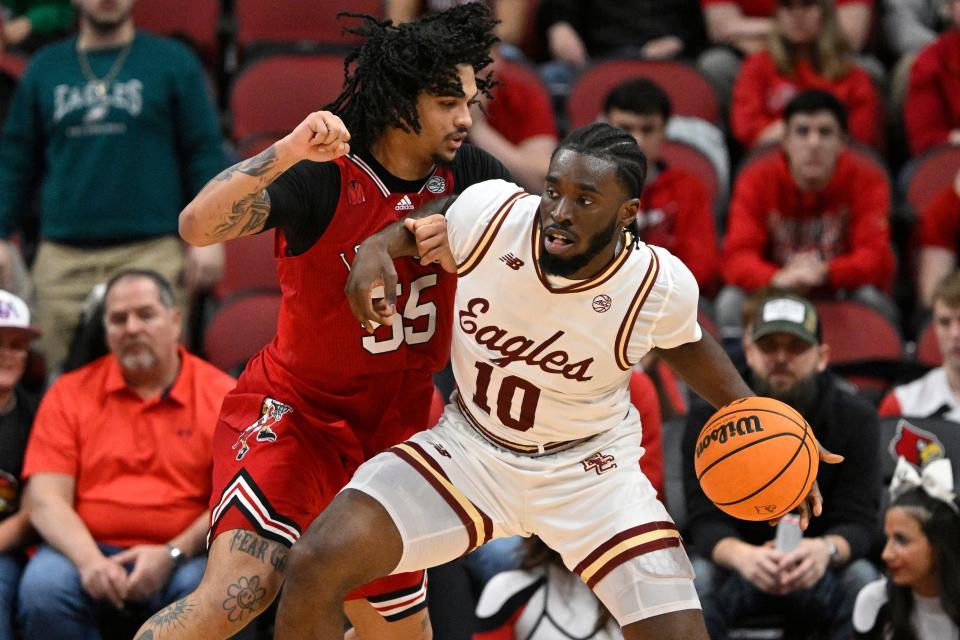 Mar 9, 2024; Louisville, Kentucky, USA; Boston College Eagles guard Prince Aligbe (10) posts up against Louisville Cardinals guard Skyy Clark (55) during the second half at KFC Yum! Center. Boston College defeated Louisville 67-61.Mandatory Credit: Jamie Rhodes-USA TODAY Sports