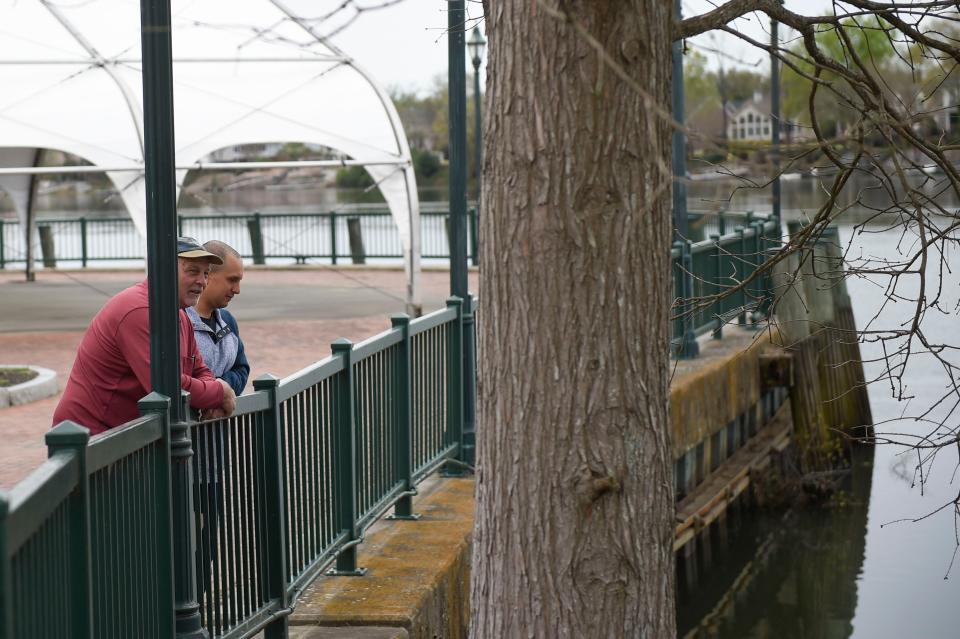 Dale Vancil (left) and son Bart Vancil, of Ill., look out over the Savannah River from the Augusta Riverwalk on a Thursday in March.