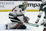 Minnesota Wild goaltender Filip Gustavsson (32) deflects an Anaheim Ducks shot during the third period of an NHL hockey game in Anaheim, Calif., Tuesday, March 19, 2024. (AP Photo/Alex Gallardo)