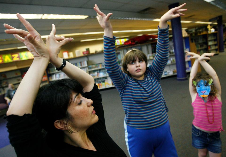 Shannon Calderón Primeau, left, instructs Mary Sue Sharp, age 12, middle, and Harper Johnson, age 6, in flamenco dancing during the Hispanic Heritage Festival at Norman Public Library in Norman, Okla. Sunday, September 30, 2007. A beloved dancer and teacher, Calderón Primeau died of cancer in 2015 at the age of 45.