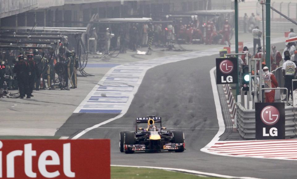 Red Bull Formula One driver Vettel exits the pit lane after his first stop during the Indian F1 Grand Prix at the Buddh International Circuit in Greater Noida