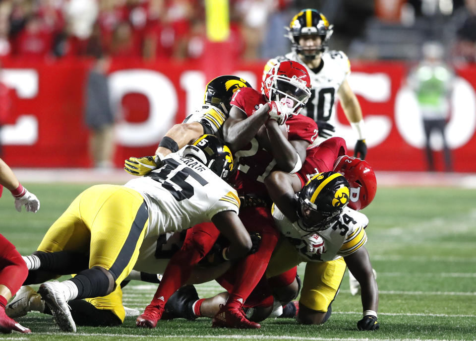 Iowa defensive lineman Deontae Craig (45) and linebacker Jay Higgins (34) stop Rutgers running back Samuel Brown V (27) during the first half of an NCAA football game, Saturday, Sept. 24, 2022, in Piscataway, N.J. (AP Photo/Noah K. Murray)