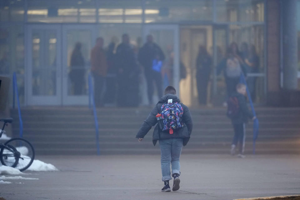 A student arrives at Perry Middle School, Thursday, Jan. 25, 2024, in Perry, Iowa. Middle school students returned to classes Thursday for the first time since a high school student opened fire in a shared cafeteria, killing two people and injuring six others. (AP Photo/Charlie Neibergall)