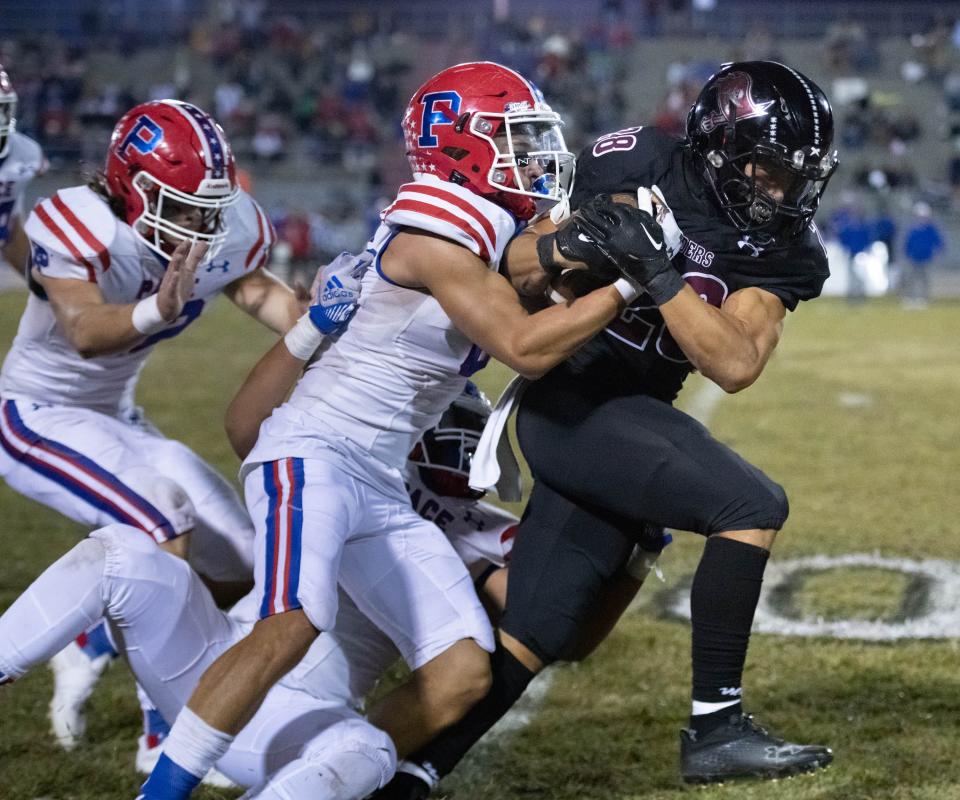 Connor Mathews (28) carries the ball during the Pace vs Navarre football game at Navarre High School on Friday, Oct. 21, 2022.