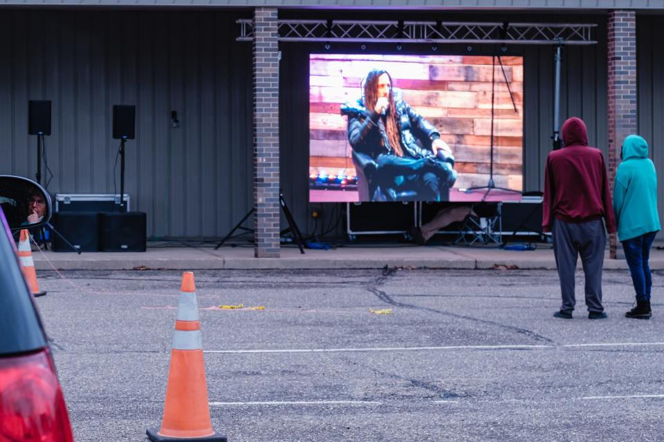 People listen in to a question-and-answer session featuring Brian "Head" Welch, vocalist and guitarist of the band Korn, and the Rev. Tommy Miller, during an addiction recovery event at Legacy Church on Friday in New Philadelphia. The event was held inside, with overflow viewing offered in the parking lot.