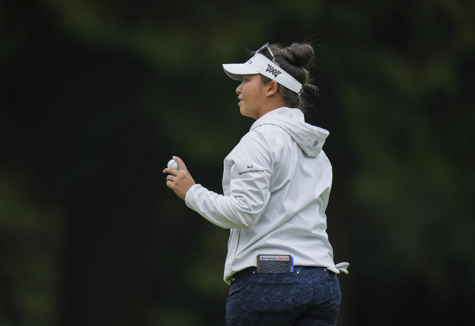 Megan Khang, of the United States, acknowledges applause from spectators after making par on the 18th hole during the second round at the LPGA CPKC Canadian Women's Open golf tournament in Vancouver, British Columbia, Friday, Aug. 25, 2023. (Darryl Dyck/The Canadian Press via AP)