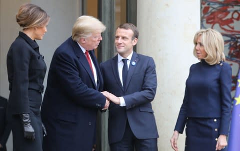 The two leaders and their wives greet one another at the Elysee Palace on Saturday - Credit: LUDOVIC MARIN/AFP/Getty Images