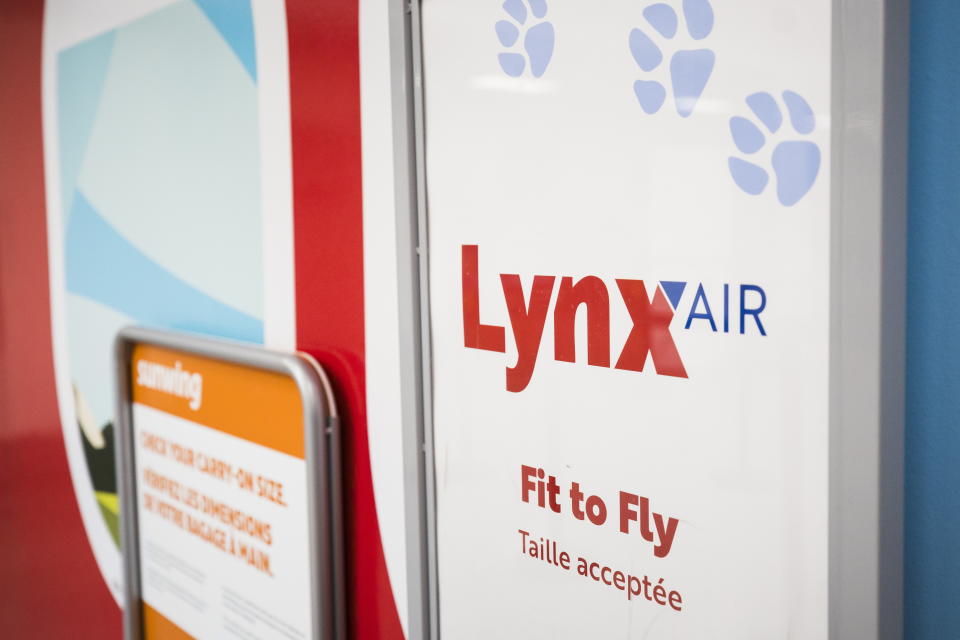 Lynx Air signage is displayed at the John C. Munro Hamilton International Airport in Hamilton, Ontario, Friday, Feb. 23, 2024. Officials with the Calgary-based company announced that it is ceasing operations after filing for creditor protection. (Nick Iwanyshyn/The Canadian Press via AP)