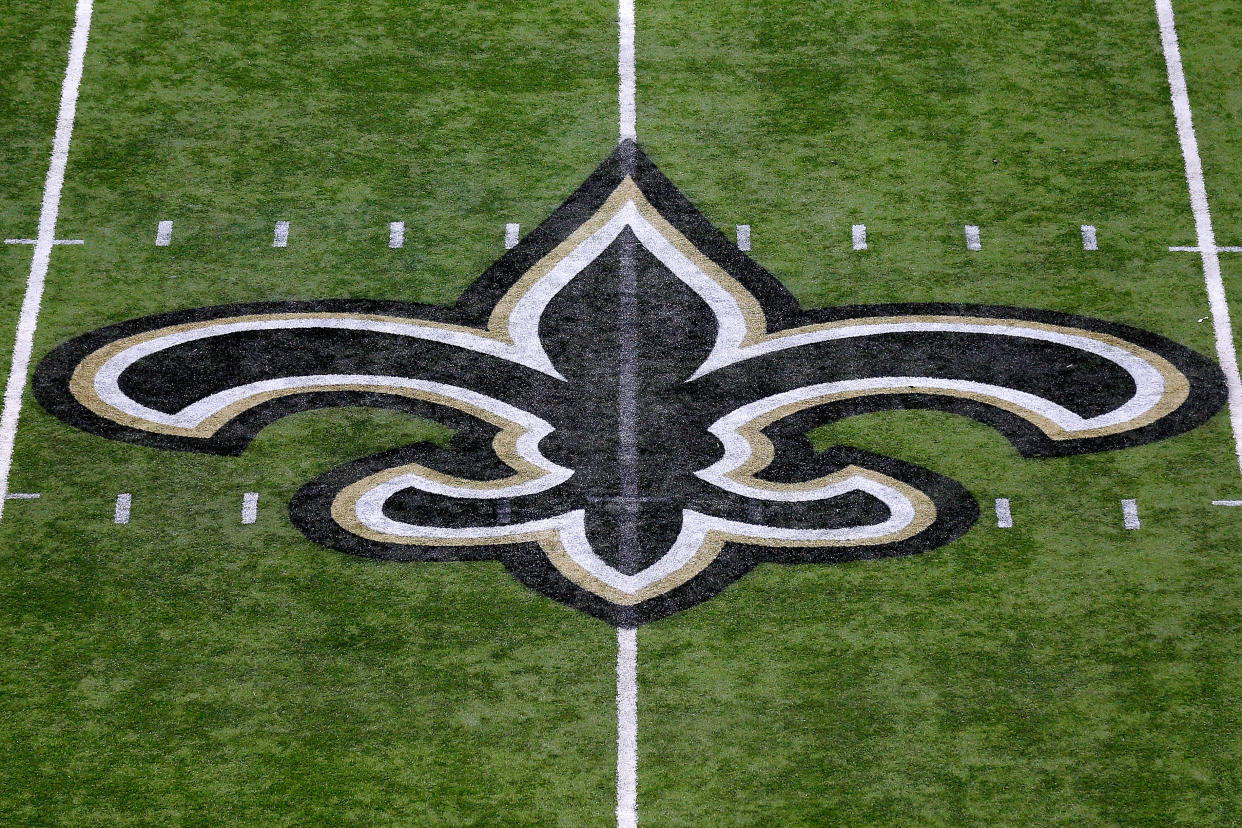 A Saints logo on the field at the Superdome.