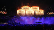 The Olympic rings are seen during a pyrotechnics display at the pre-show before the opening ceremony of the London 2012 Olympic Games at the Olympic Stadium July 27, 2012. REUTERS/Suzanne Plunkett (BRITAIN - Tags: SPORT OLYMPICS) 