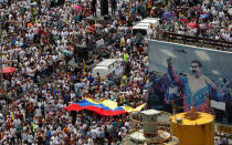 Opposition supporters take part in a rally against Venezuela's President Nicolas Maduro next to a poster of him in Caracas, Venezuela, October 26, 2016. REUTERS/Christian Veron