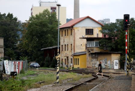 A man walks through Bubny railway station in Prague