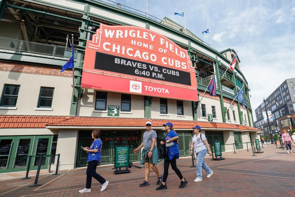 Baseball fans arrive for a game between the Chicago Cubs and Atlanta Braves at Wrigley Field.