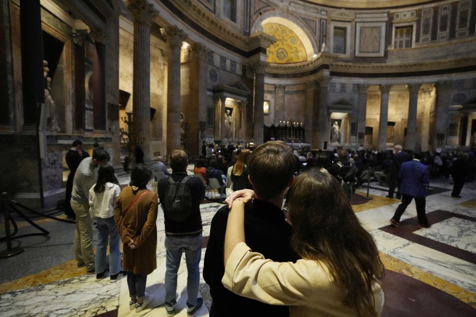 Faithfuls watch during a Latin Mass at Rome's ancient Pantheon basilica, in Rome, Italy, Friday, Oct. 29, 2021. Traditionalist Catholics descended on Rome on Friday for their annual pilgrimage, hoping to show the vibrancy of their community after Pope Francis issued a crackdown on the spread of the Latin Mass that many took as an attack on the ancient rite. An evening vespers service at Rome's ancient Pantheon basilica, the first event of the three-day pilgrimage, was so full that ushers had to add two rows of chairs to accommodate the faithful. Many young families, couples and priests filled the pews, hailing from the U.S., France, Spain and beyond. (AP Photo/Luca Bruno)